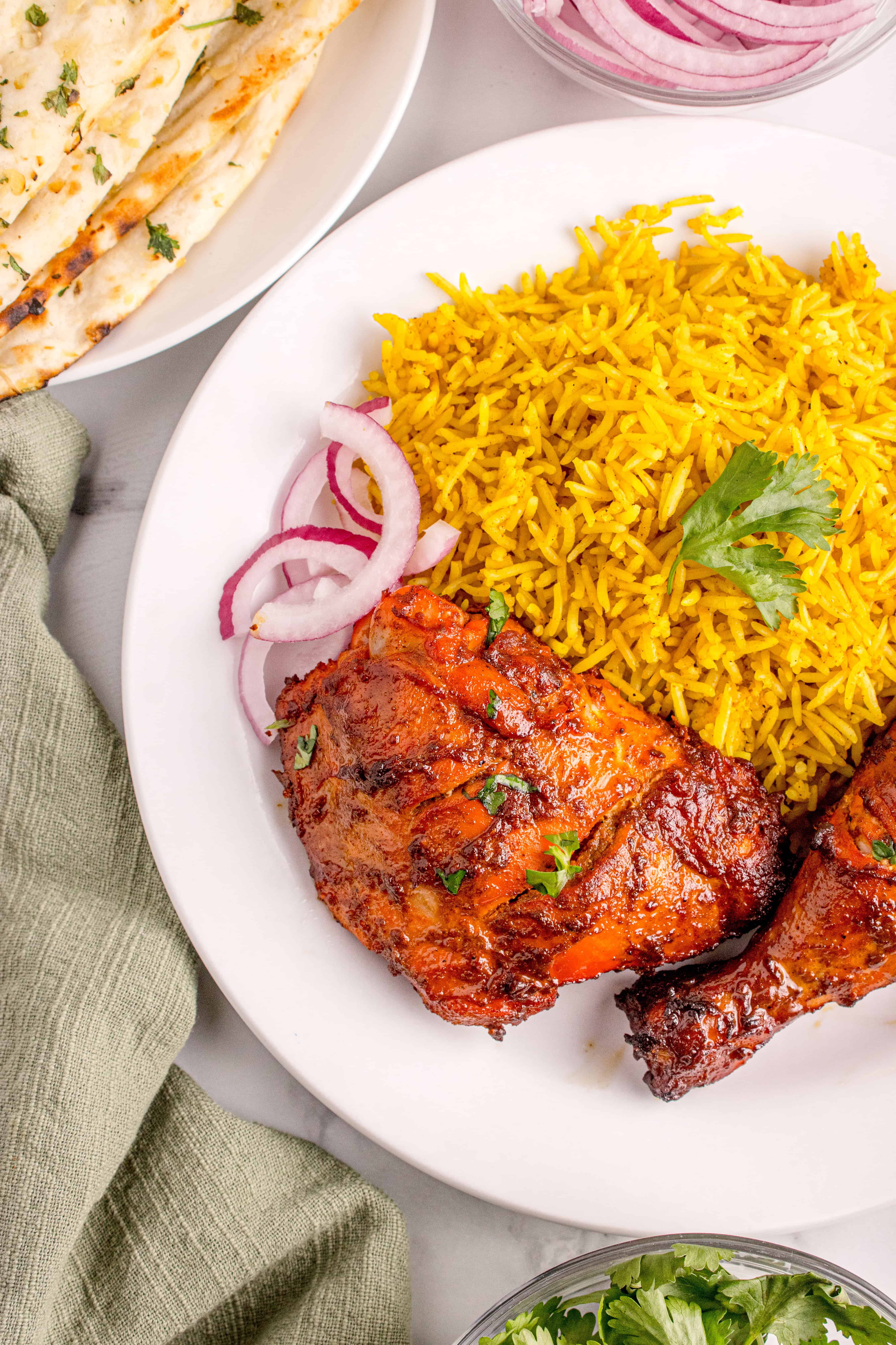 Chicken on a plate with rice and naan