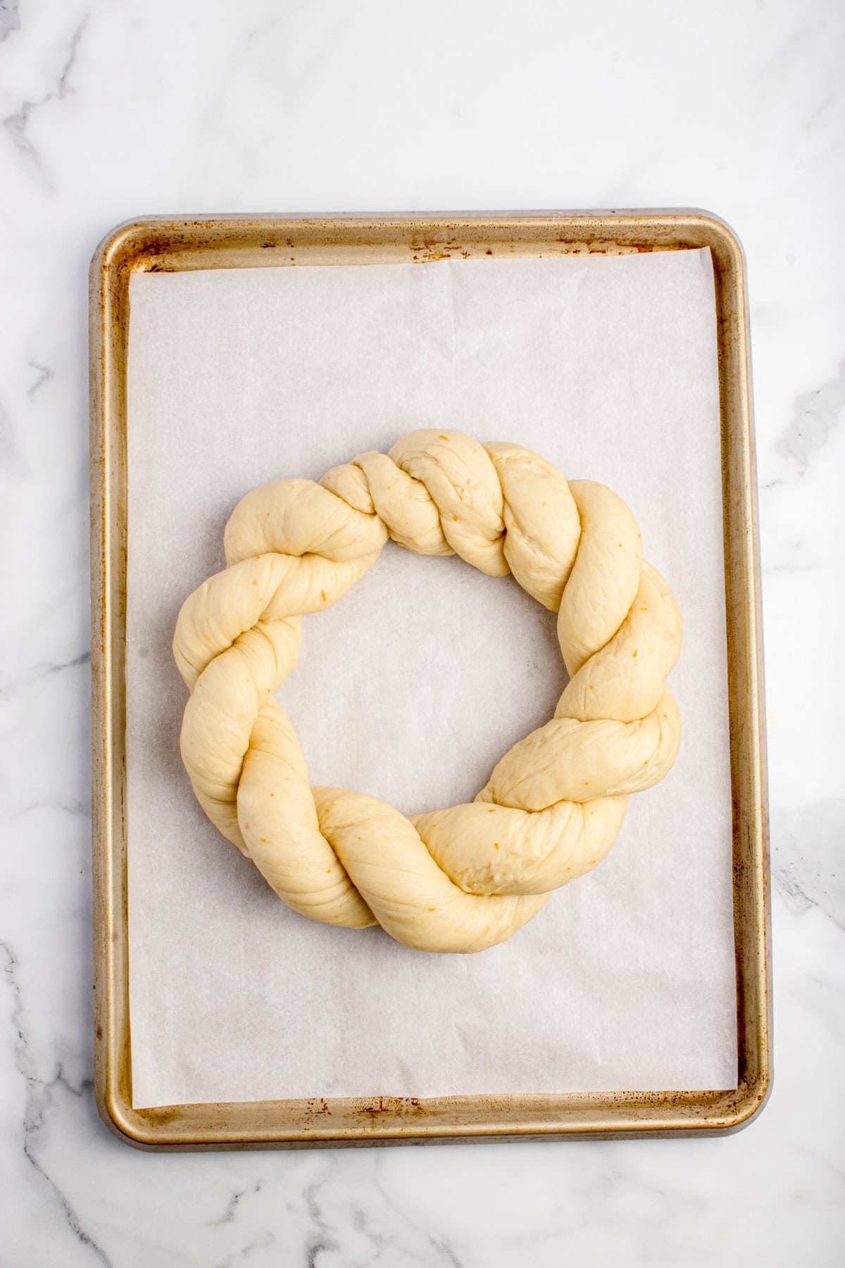 Easter wreath bread dough rising on pan