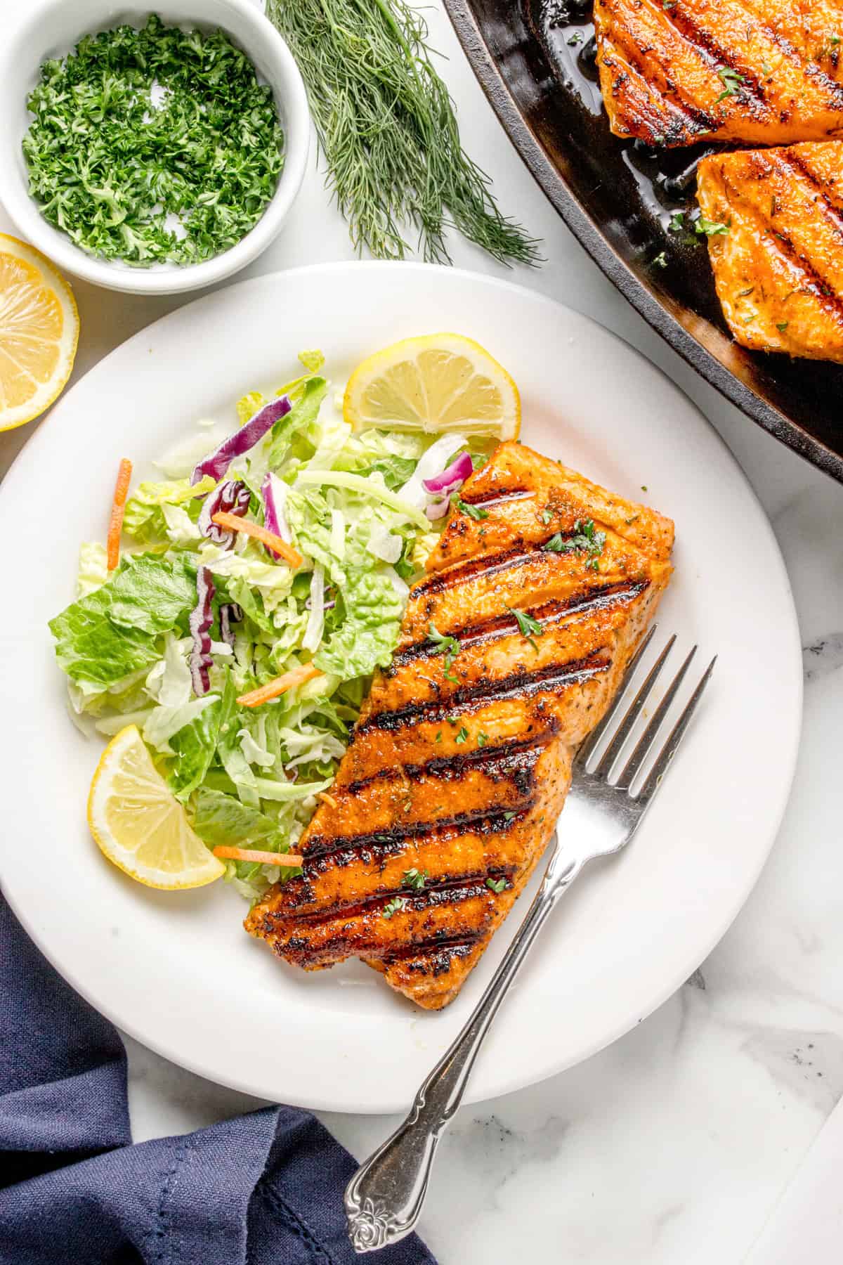 Plate with salmon and a salad on it. 