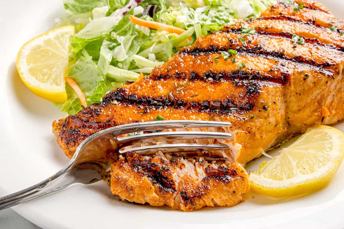 Fork cutting through the Lemon Salmon