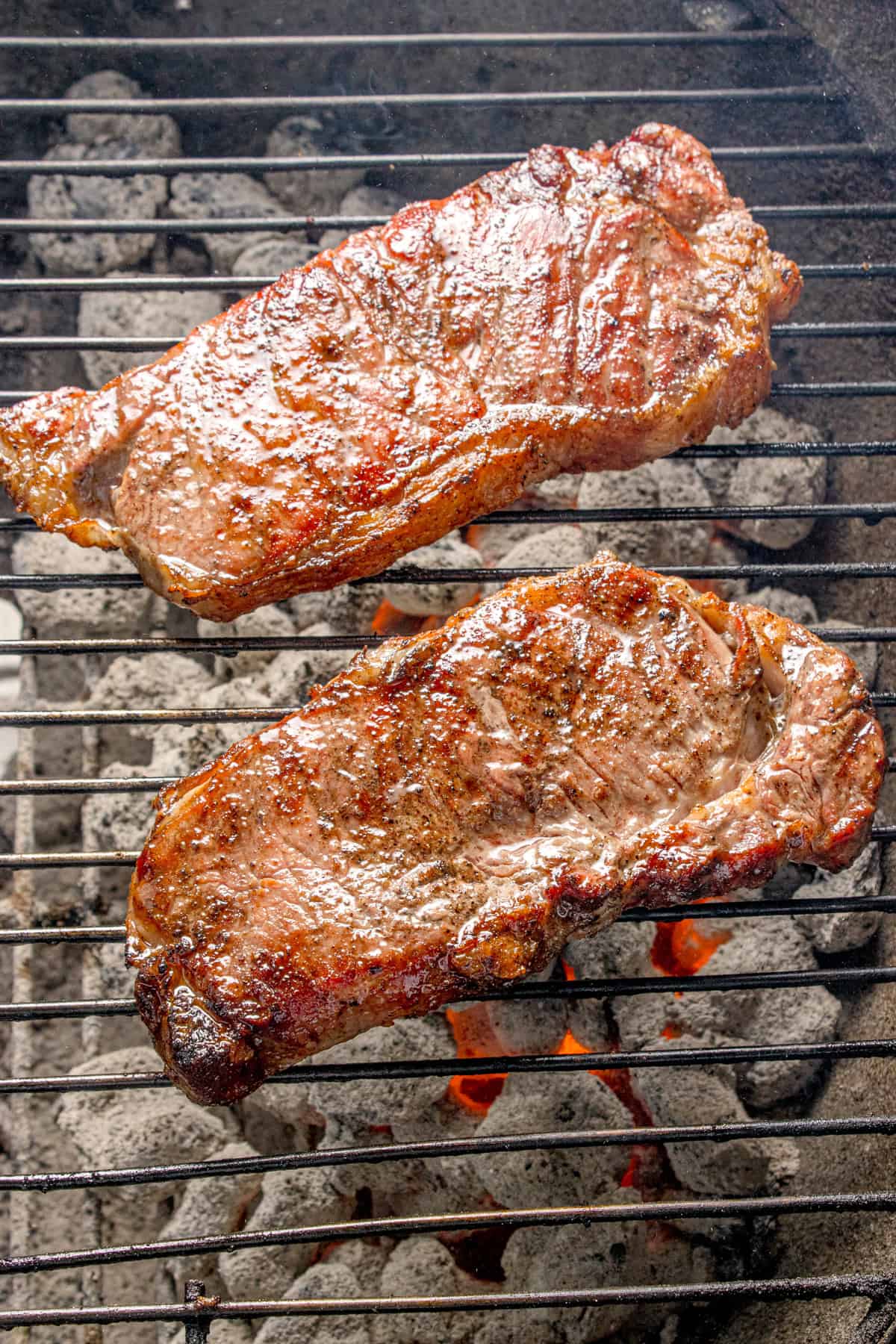 Steak directly over the coals in the grill