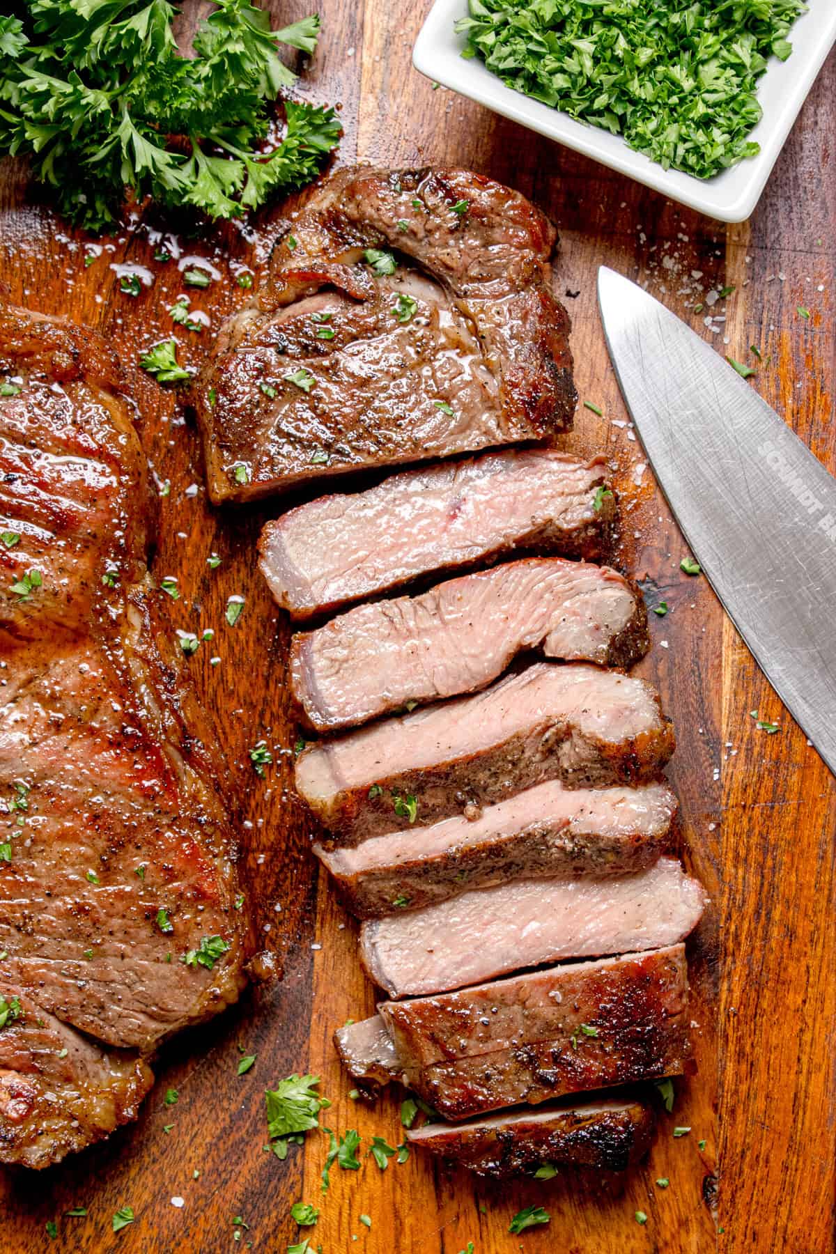 Steak that has been cut on a cutting board