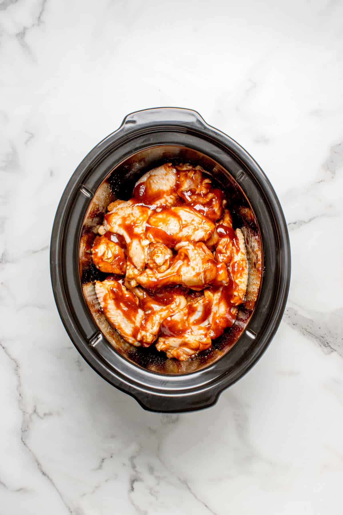 uncooked wings in a slow cooker