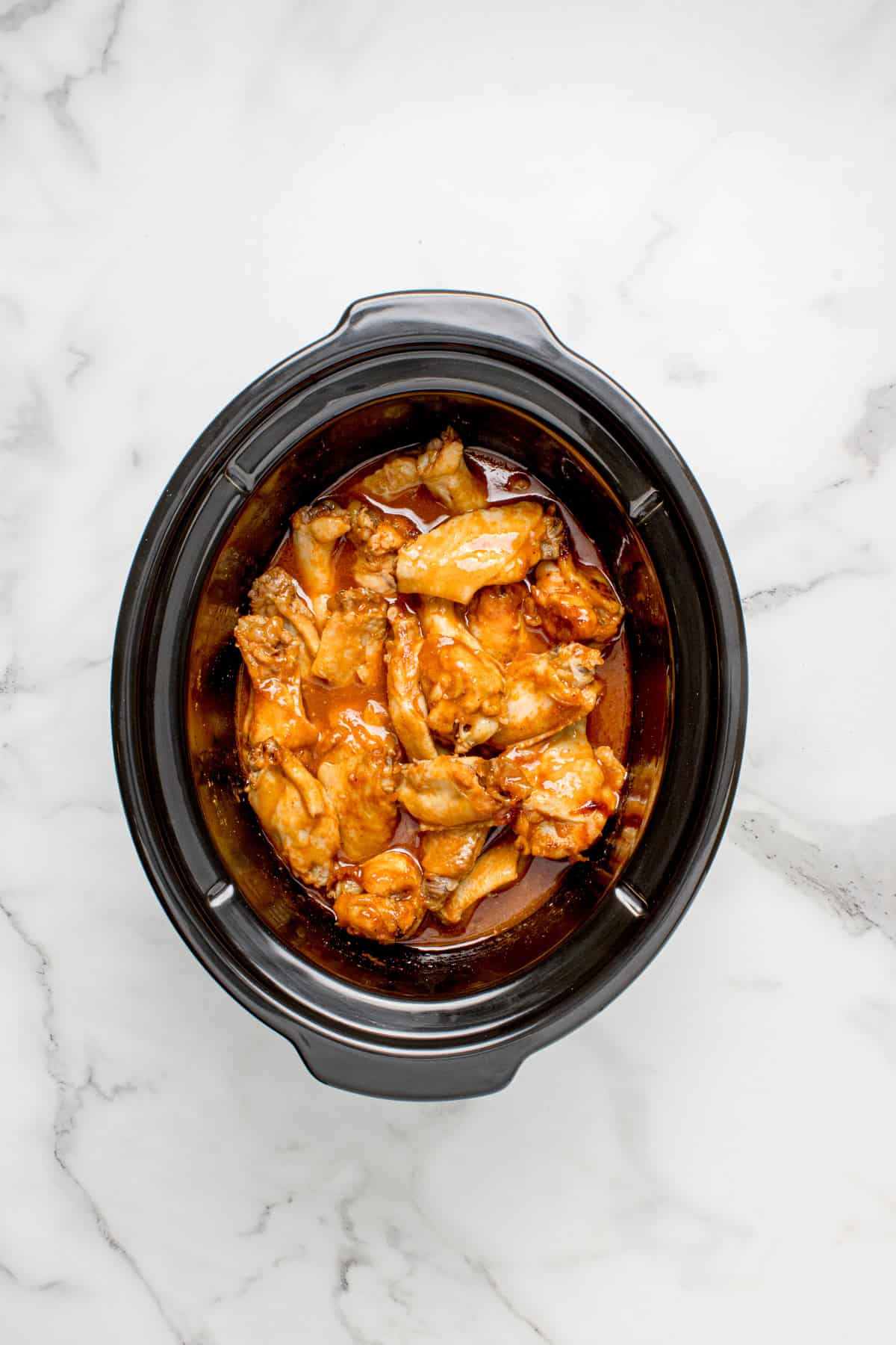 Cooked wings in a slow cooker
