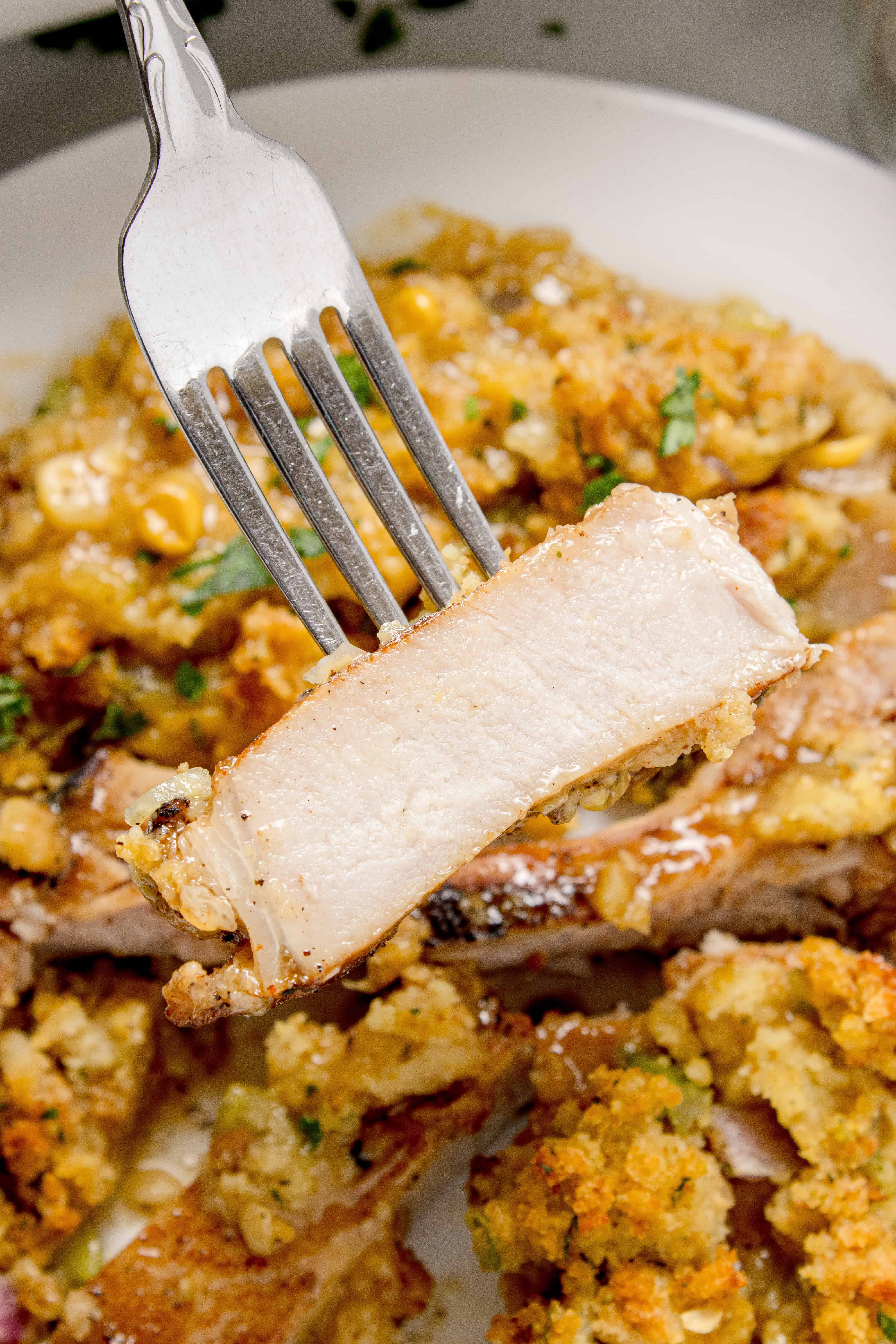 Fork holding a pork chop