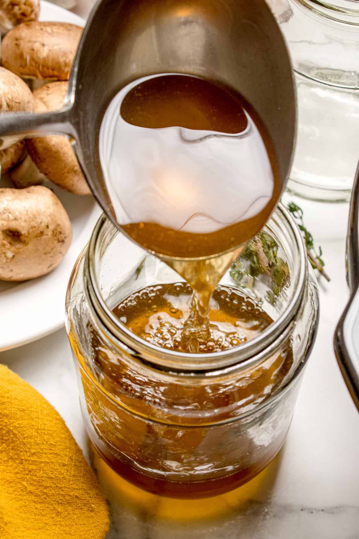 Pouring broth into a jar